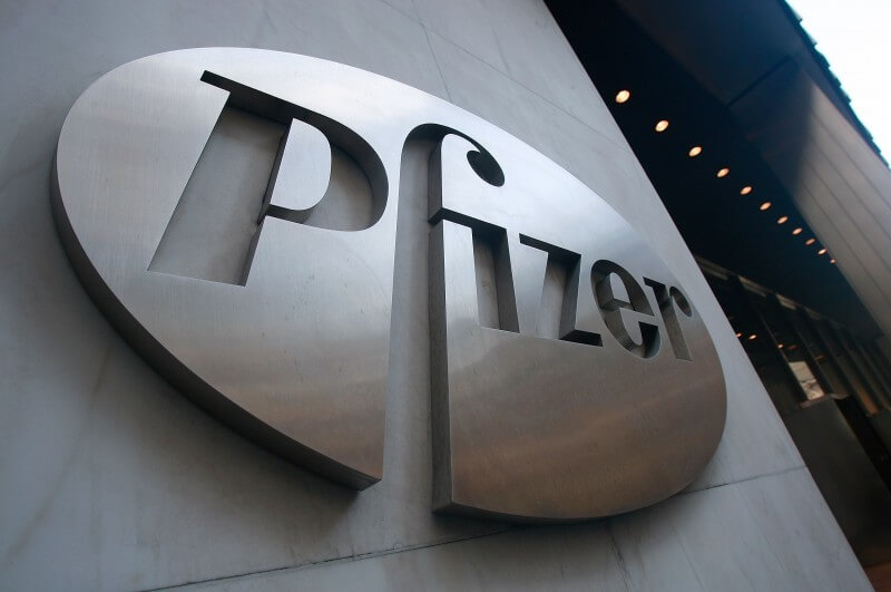 NEW YORK - JANUARY 26:  A Pfizer sign hangs on the outside of their headquarters after a news conference discussing the planned merger of Pfizer and Wyeth January 26, 2009 in New York City. Pfizer plans to acquire Wyeth for $68 billion creating the world's largest biopharmaceutical company.  (Photo by Mario Tama/Getty Images)