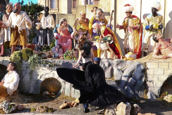 A Vatican gendarme attempts to block a topless activist of women's rights group Femen, who tries to reach the Nativity scene in Saint Peter's square at the Vatican